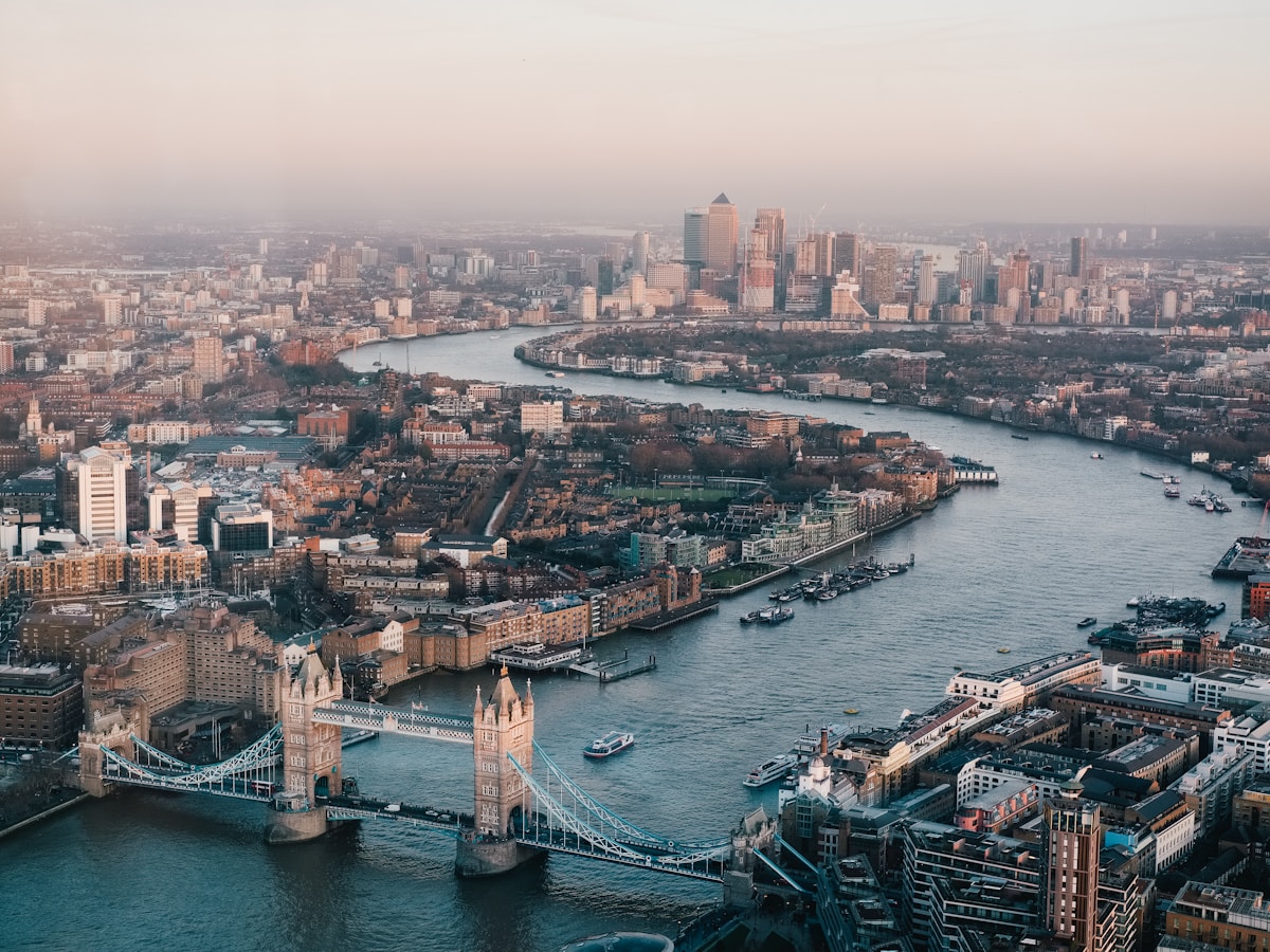 London skyline at dusk with the River Thames and historic buildings.